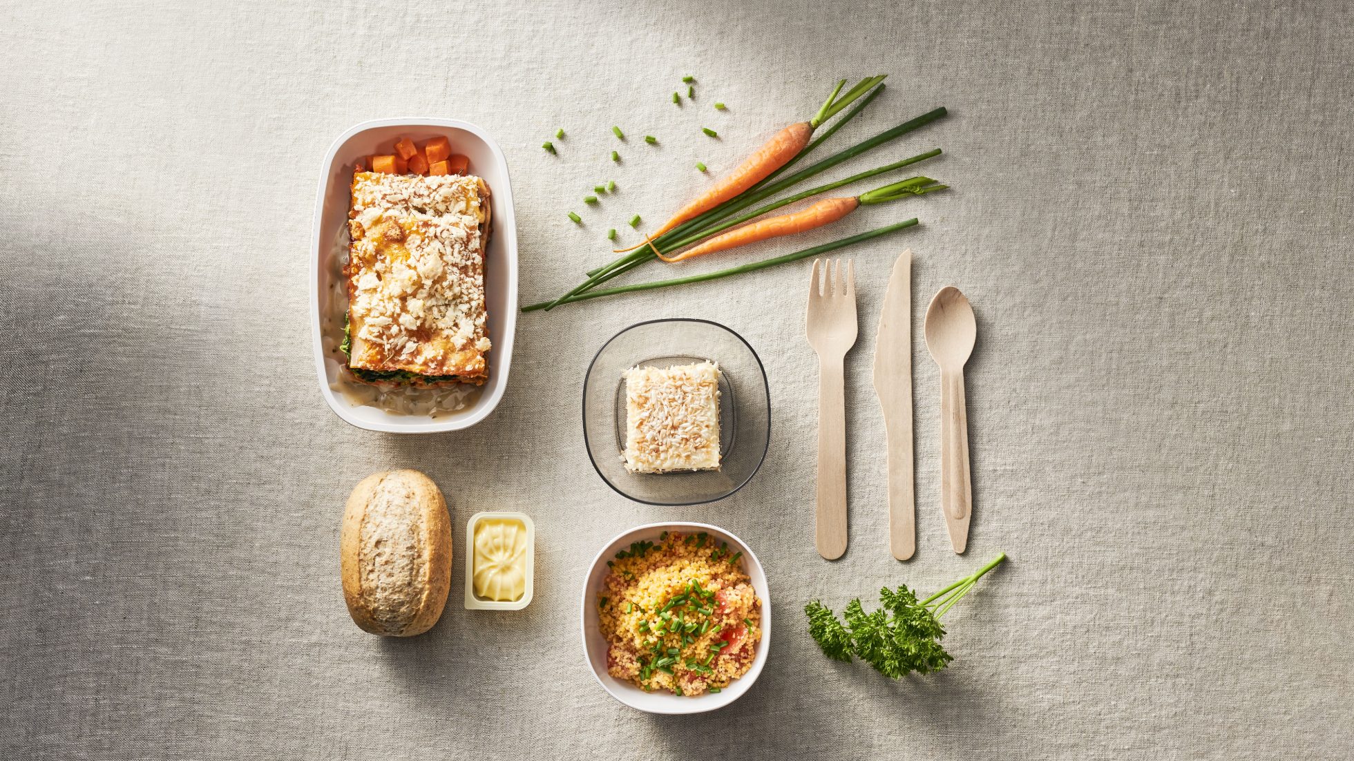 Airline meal tray with various dishes.